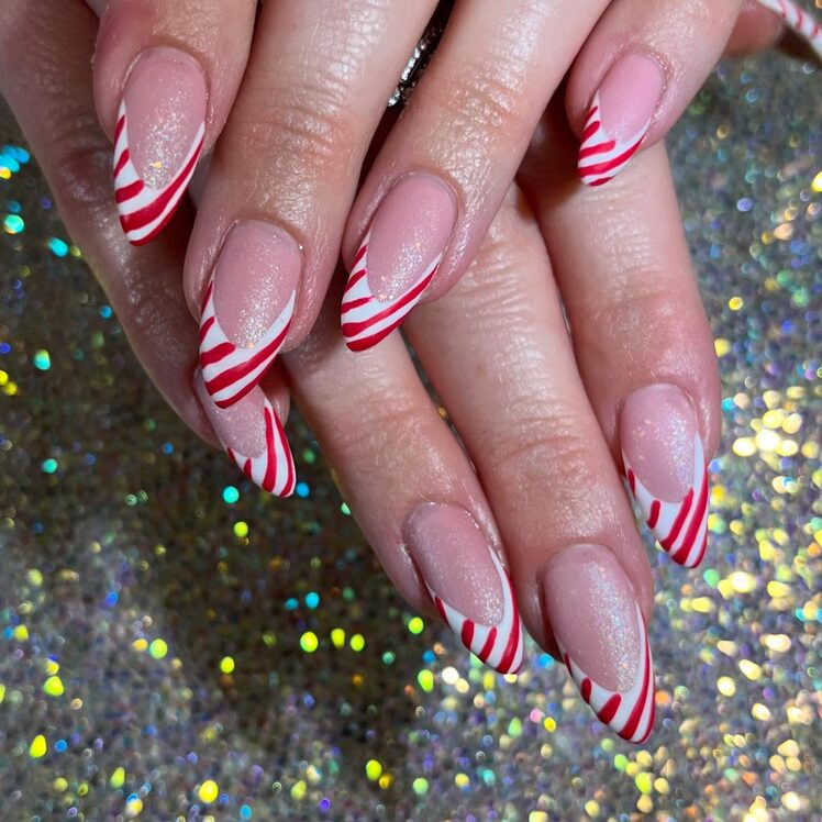 Classic red and white candy cane striped French tip manicure