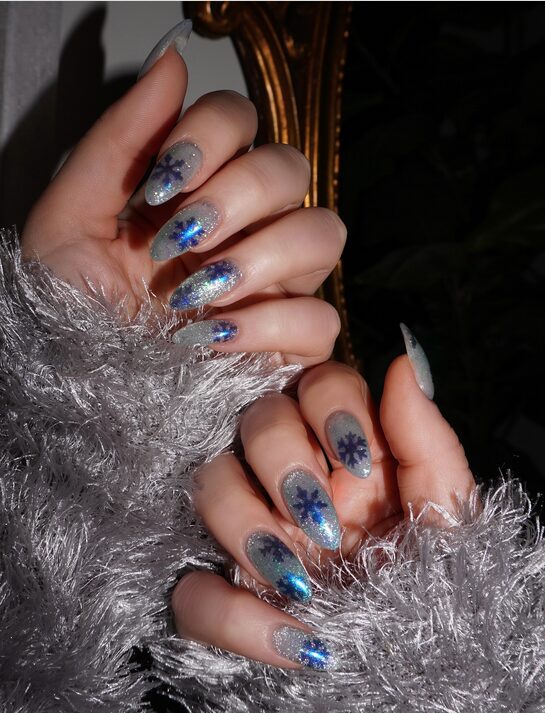Frosty silver nails featuring detailed white snowflake art on each nail