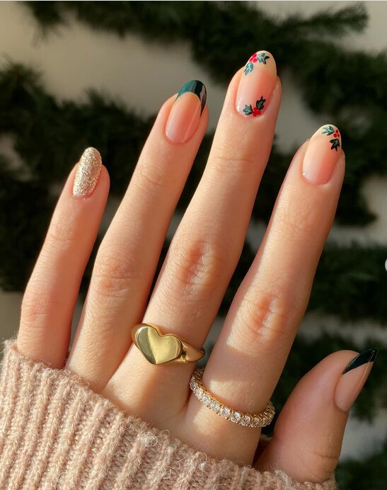 Minimal nude nails with delicate green holly leaves and red berry accents