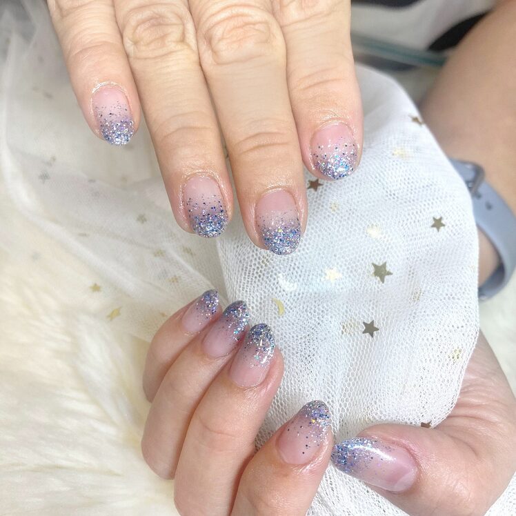 holiday nails showing icy blue glitter spread across full set
