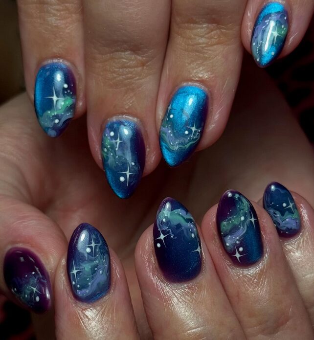 Gel manicure with shimmering aurora‐borealis waves of teal, purple and silver