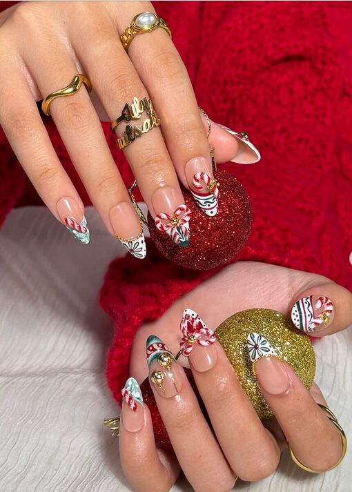 Swirled peppermint-twist nail art in red and white with sparkly glitter accent nails