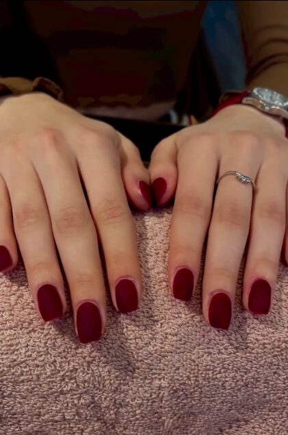 Matte ombré red-velvet nails fading from burgundy to cherry red
