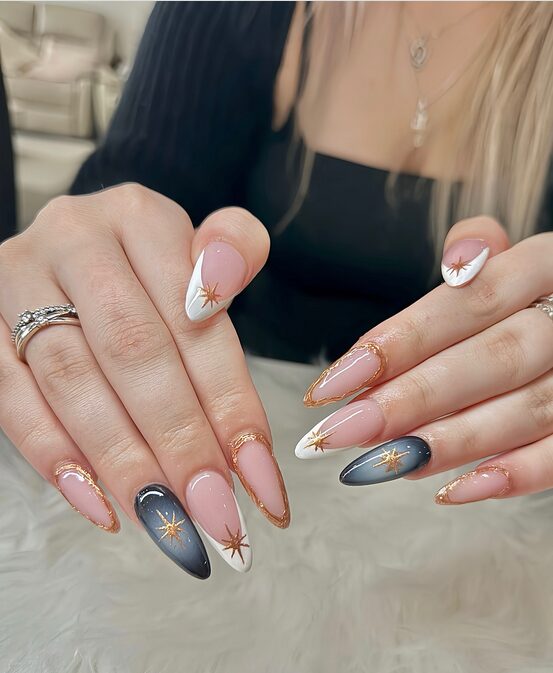 Crisp white nails with delicate gold star illustrations and subtle ombré shimmer