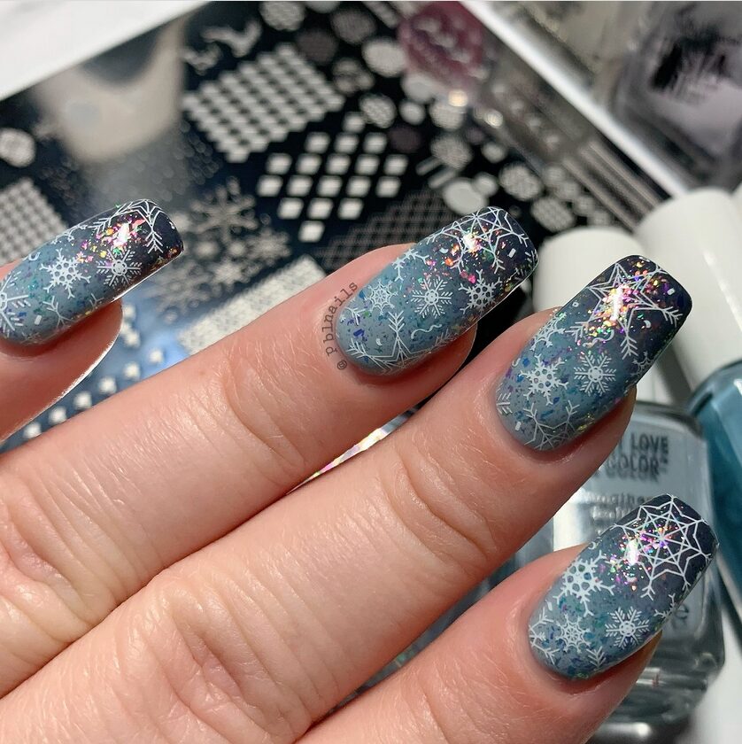 Navy blue nails with metallic silver snowflake nail art