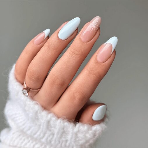 Neutral nails with a single snowflake accent for a minimalist manicure