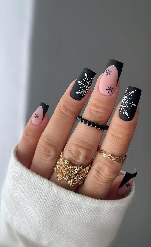 Matte black nails with white snowflake designs