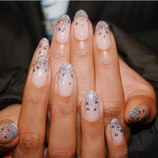 Blue-to-white ombre nails with delicate snowflake designs