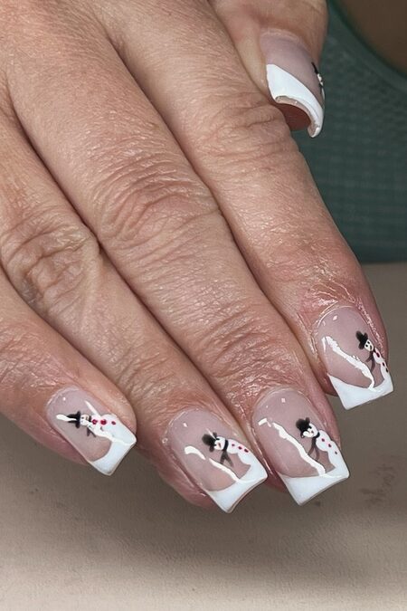 French tip nails with small snowman details
