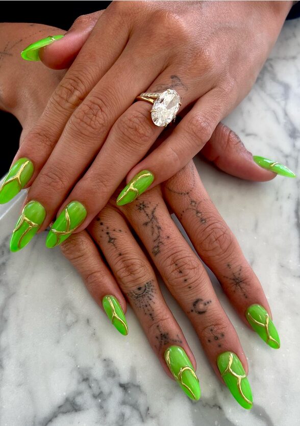 Bright green nails glowing in dim light