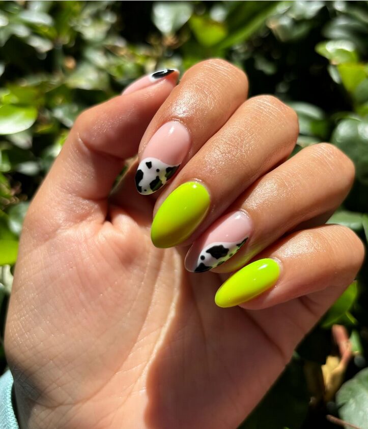 Bright lime green nails with cow print in black and white