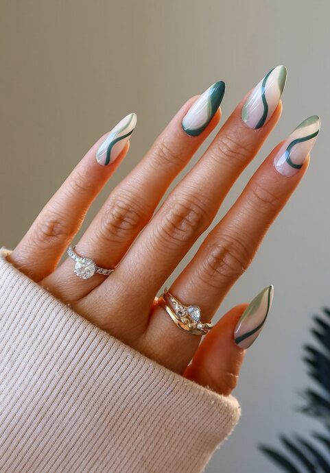 green nails with white swirl patterns
