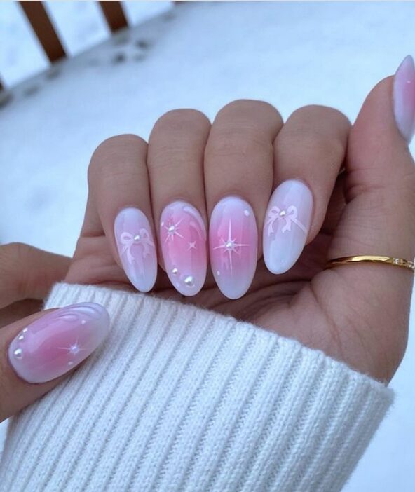 Soft pink coquette nails with tiny ribbon bow