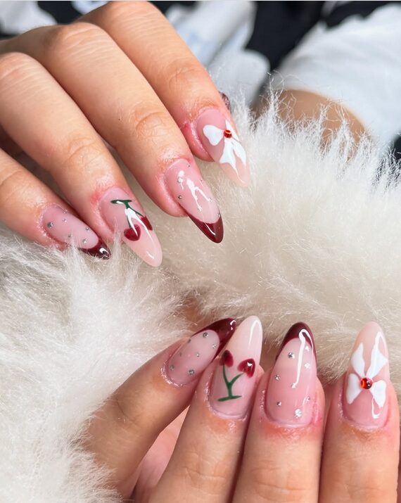 cherry nail art with bow on nude base