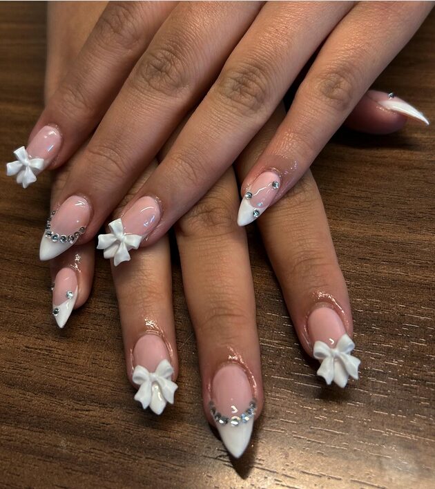 Nude blush nails with white satin bow accents