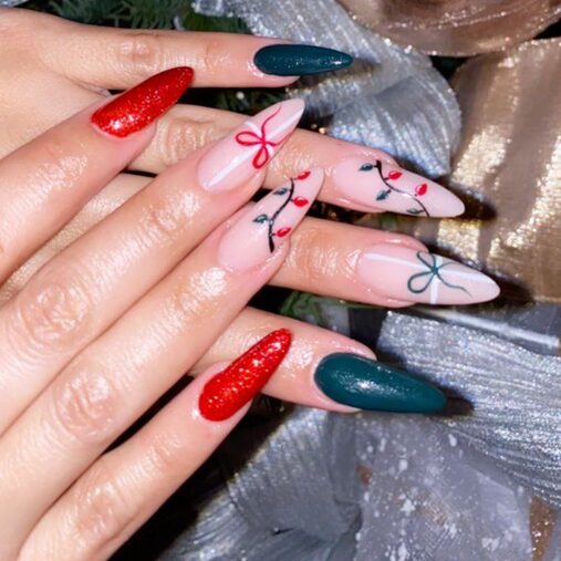 Festive Christmas nails with green, red, and gold bow designs