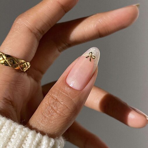 Gold foil nails with metallic bow accents