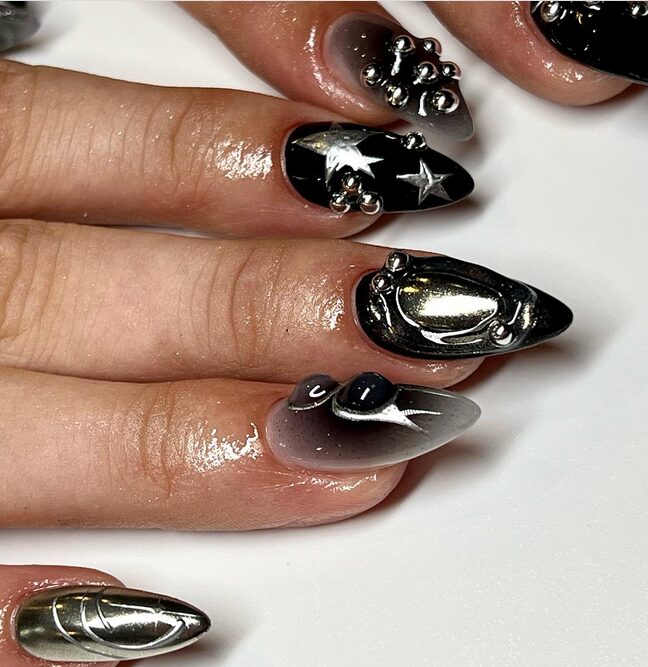 Black chrome nails with a reflective grunge-inspired finish