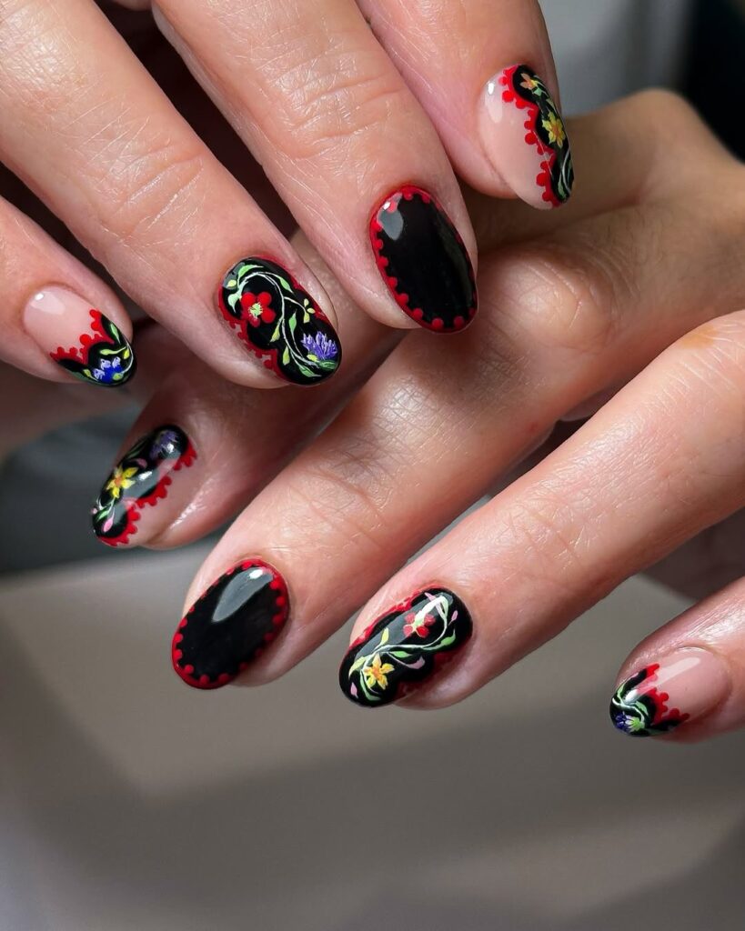 Black nails with colorful folk art flowers and red scalloped borders