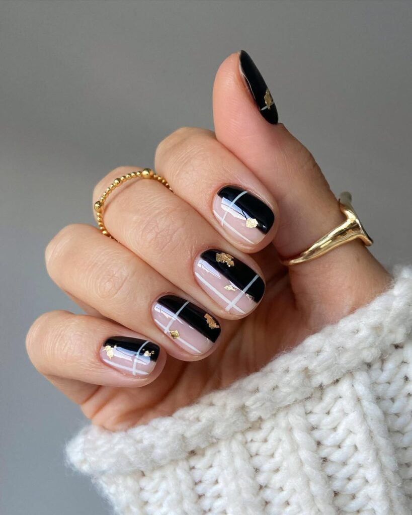 Black and nude plaid nails with gold foil accents