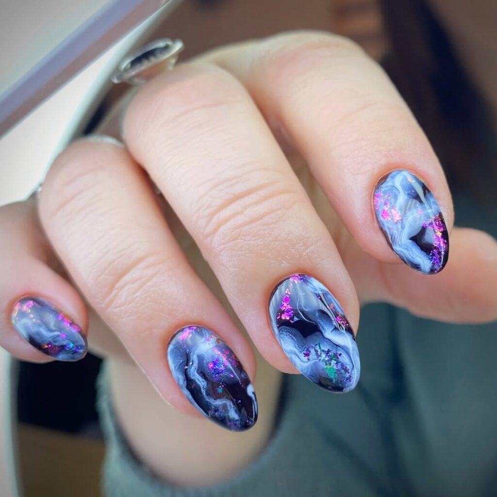 Black smoky marble nails with iridescent pink and purple glitter