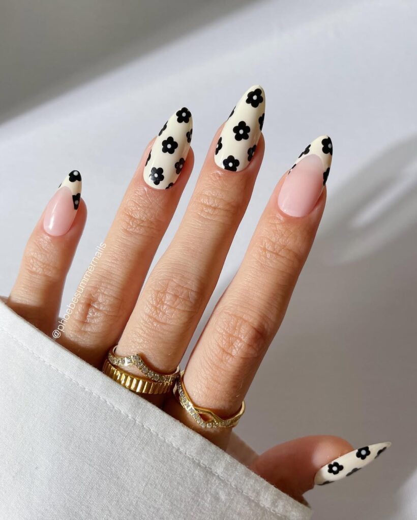 Cream nails with black daisy flower pattern