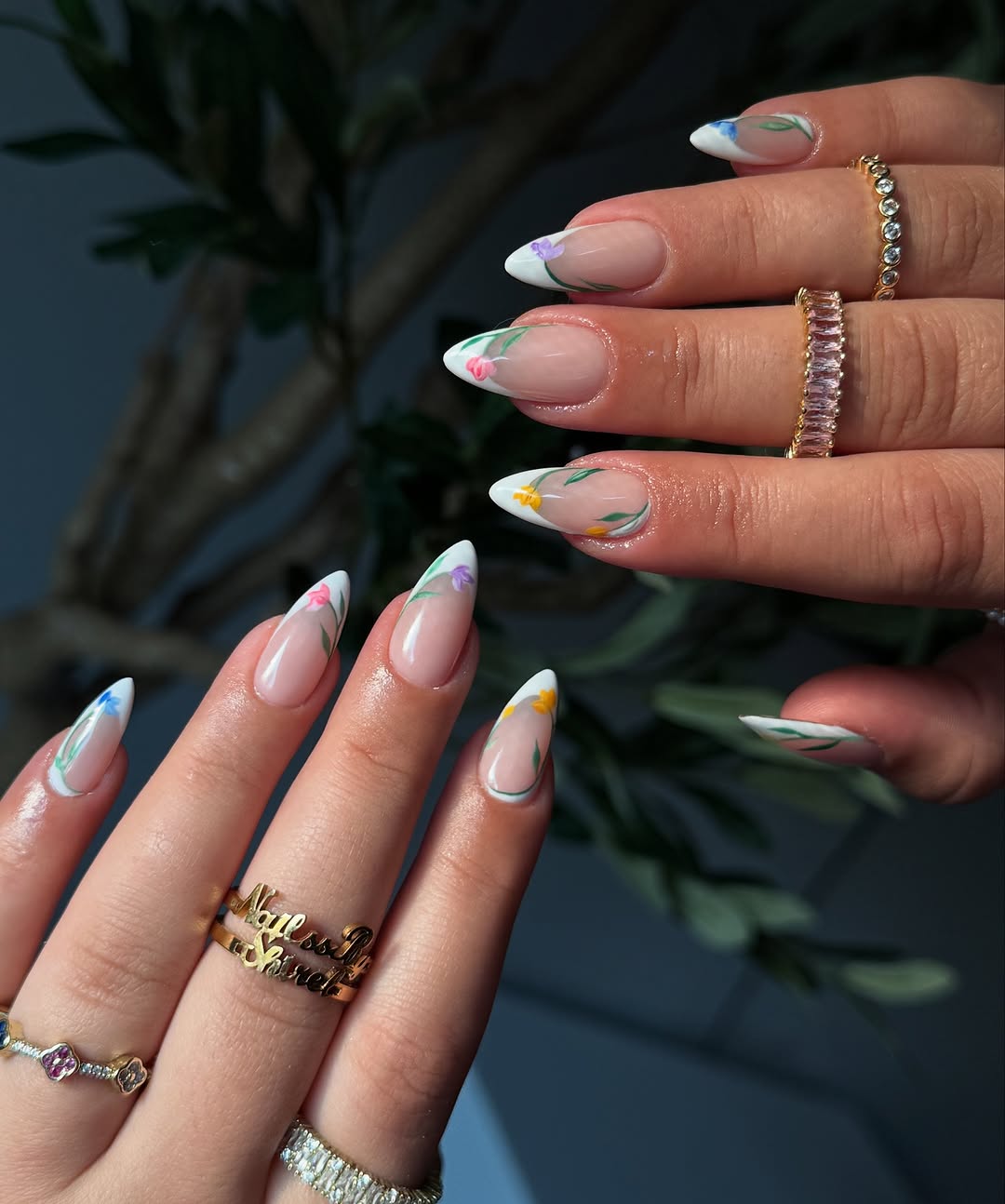 nude nails with white French tips and small colorful florals