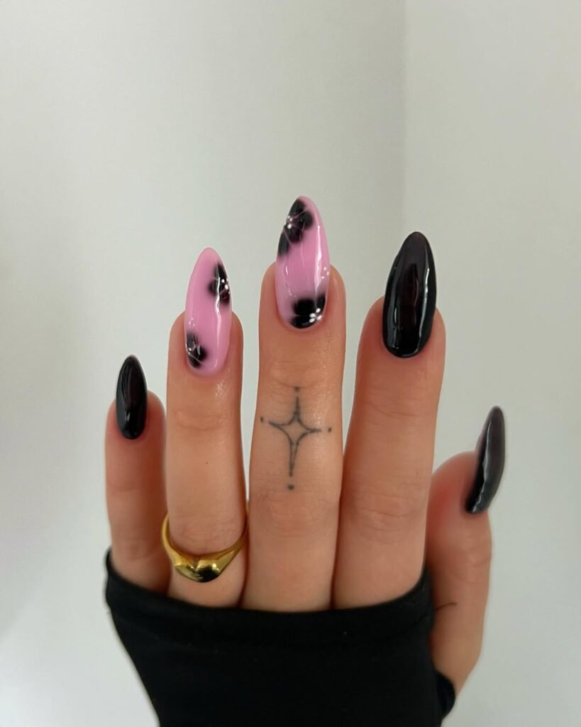black and pink nails with delicate floral designs