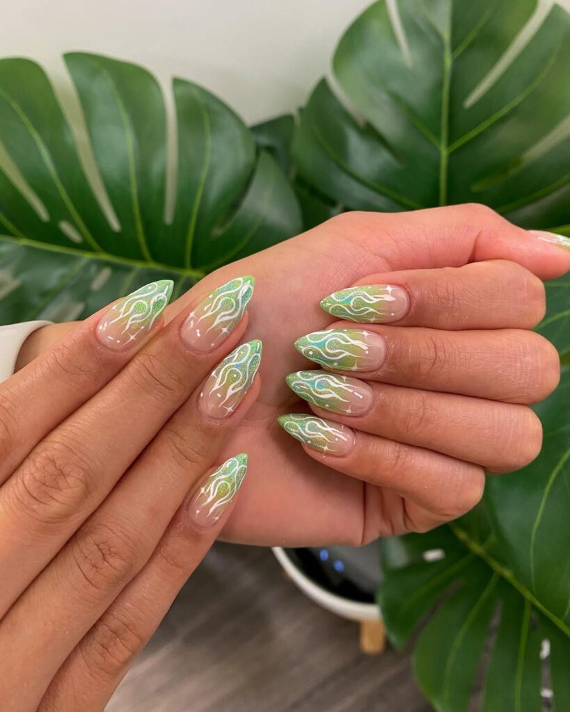 nails with green abstract swirl design on nude base