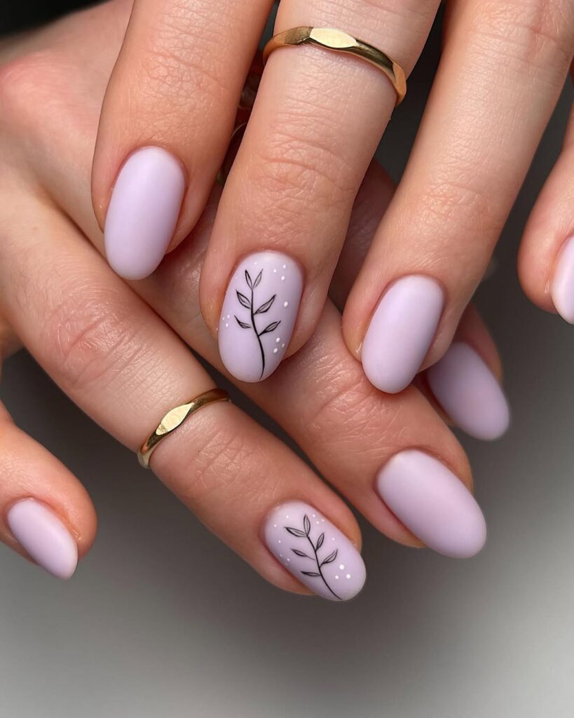Soft lavender matte nails with delicate black leaf branch accent