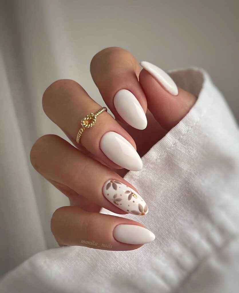 matte white almond nails with minimal gold leaf accent design