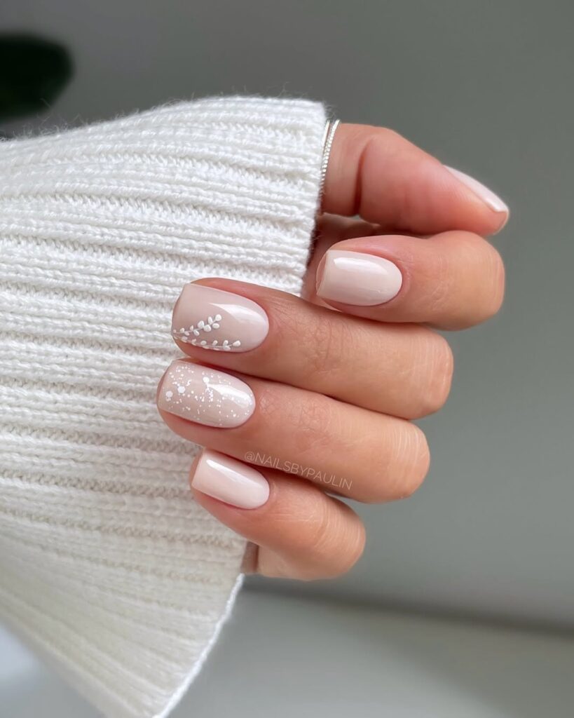 square milky white nails with delicate leaf and speckle accents