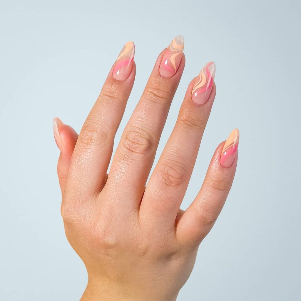 nails with peach and pink abstract swirl design