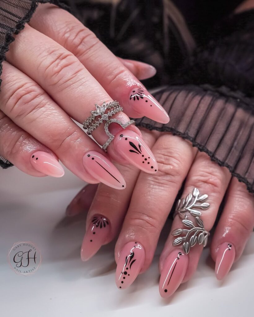 Blush pink nails with delicate black botanical line art designs