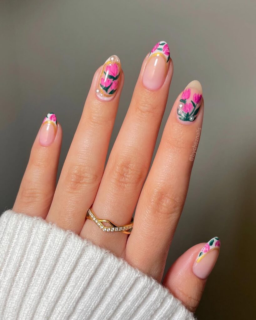 nails with pink hand-painted floral designs and gold detailing