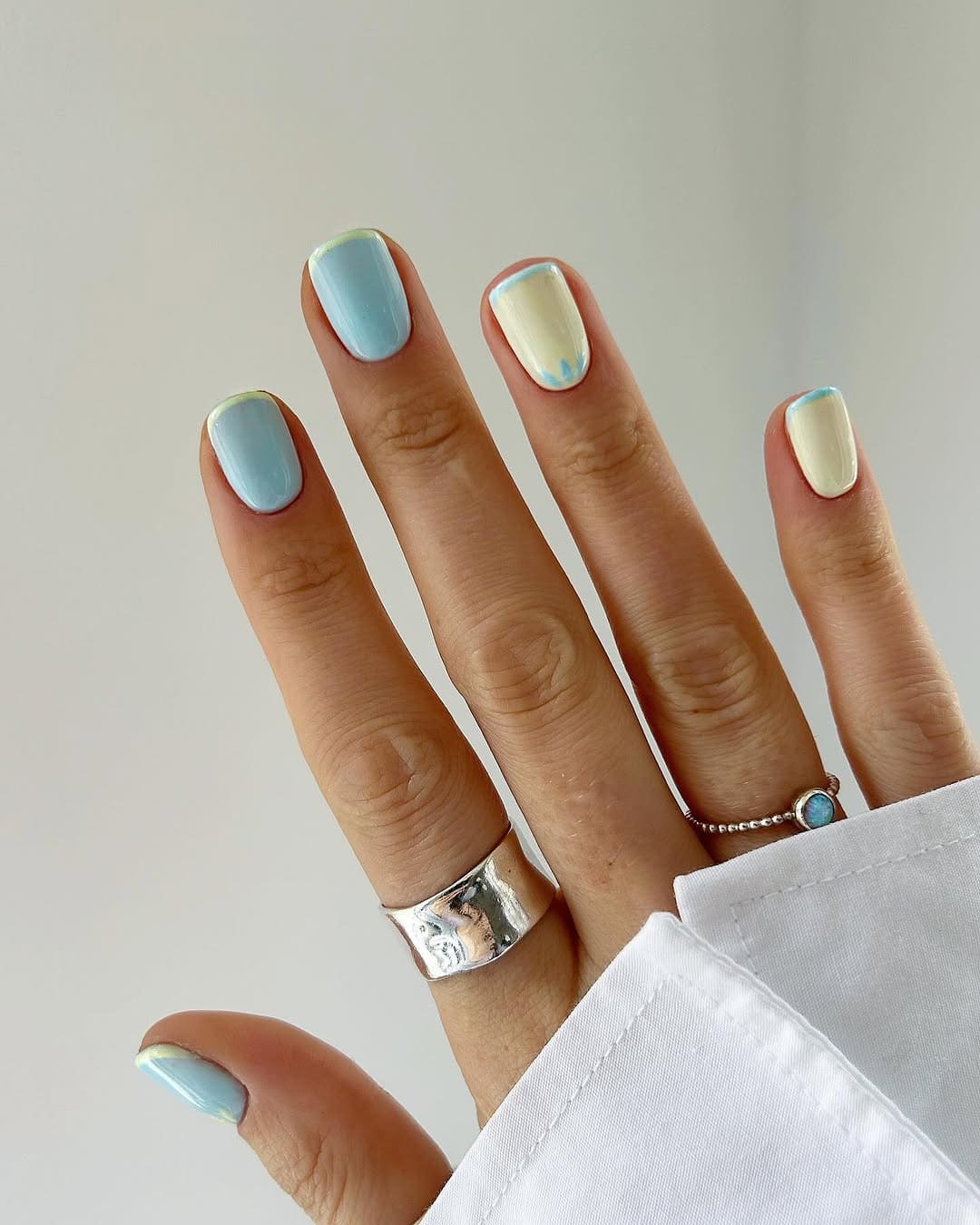 pastel blue and cream spring manicure with minimalist drip tips