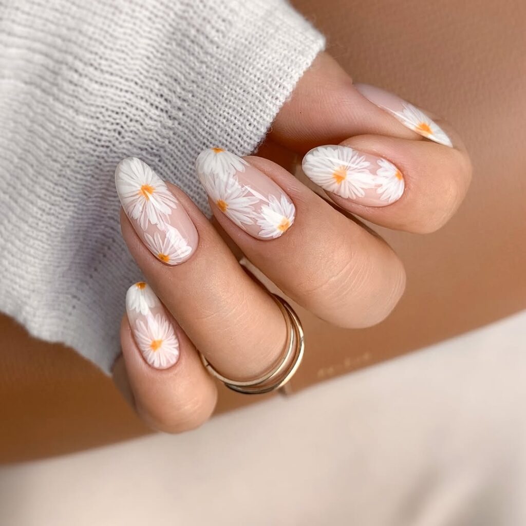nude nails with white daisy flowers