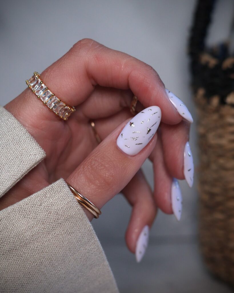 white nails with gold foil flecks
