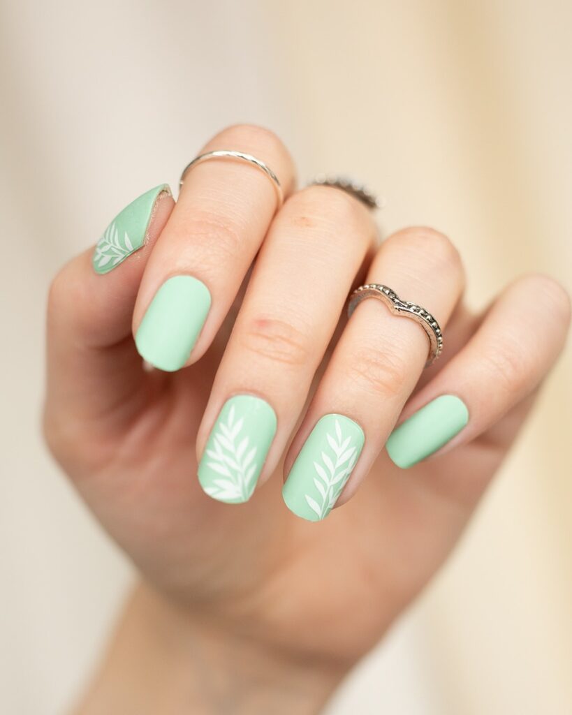 mint green spring nails with white botanical art