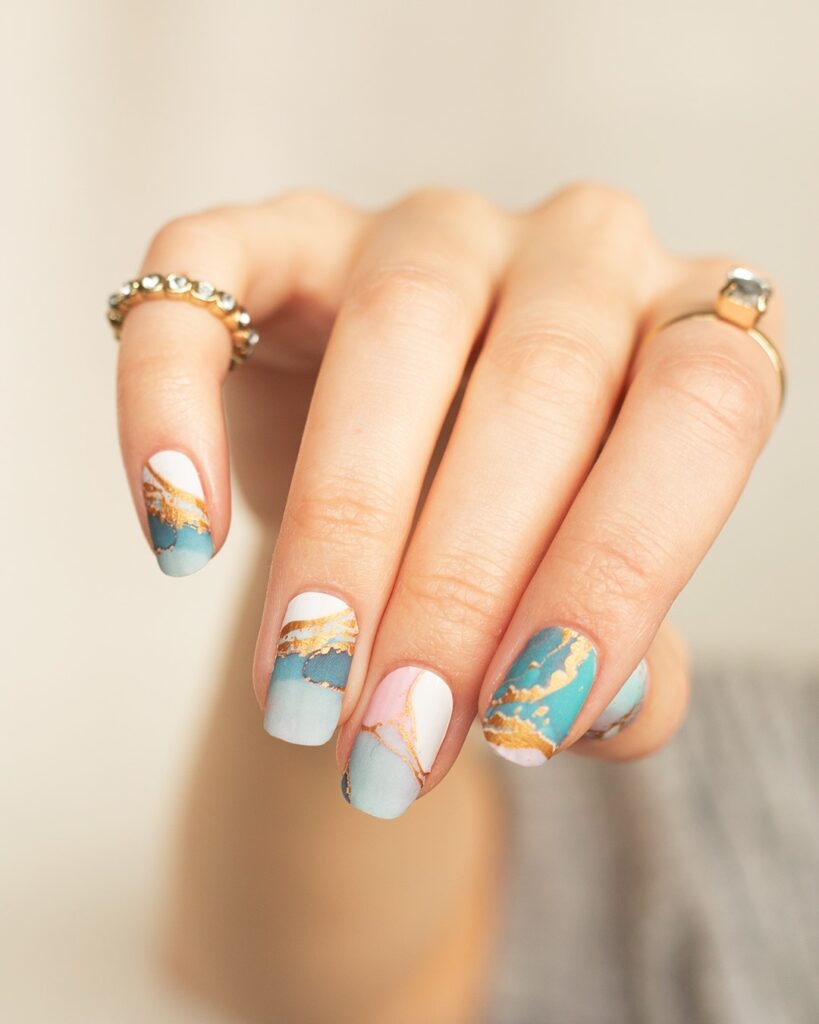 teal and blush marble nails with gold veins