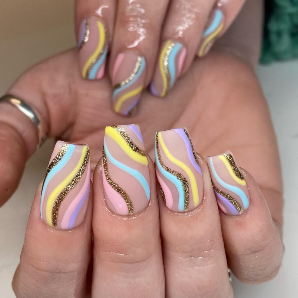 pastel rainbow swirl nails with gold glitter