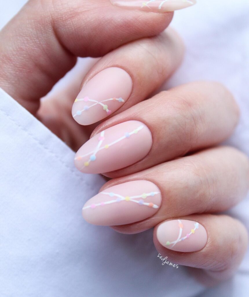 nude nails with pastel branch art