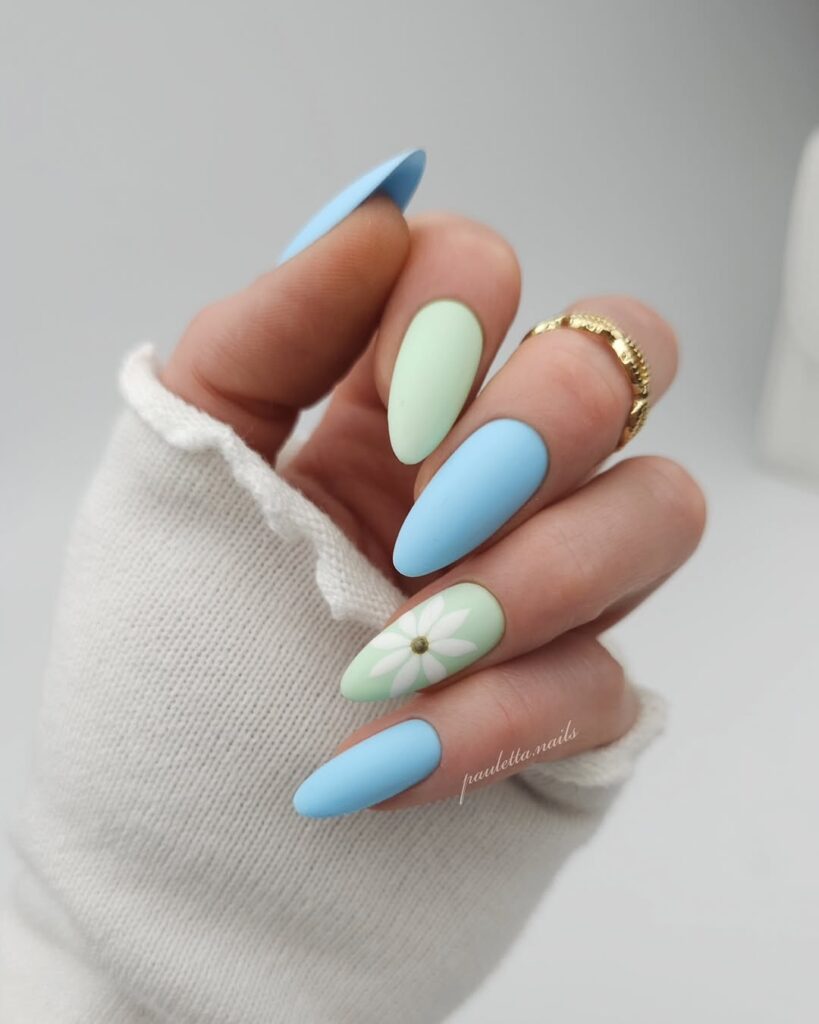 sky blue and mint green nails with daisy accent