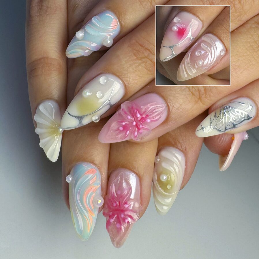 Colorful 3D butterfly and floral nails with sculpted designs and pearl accents