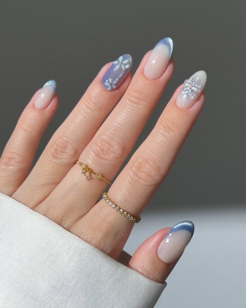 blue chrome French tip manicure and 3D white flower accents