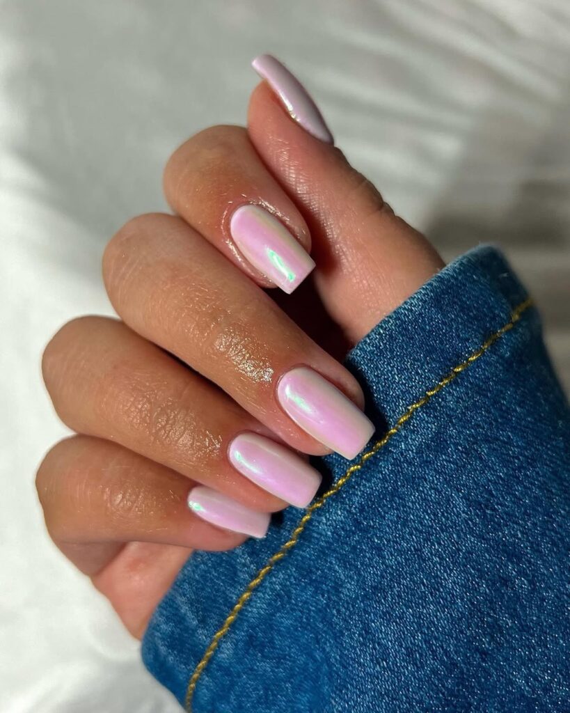 nails in soft blush pink chrome with a subtle iridescent shift