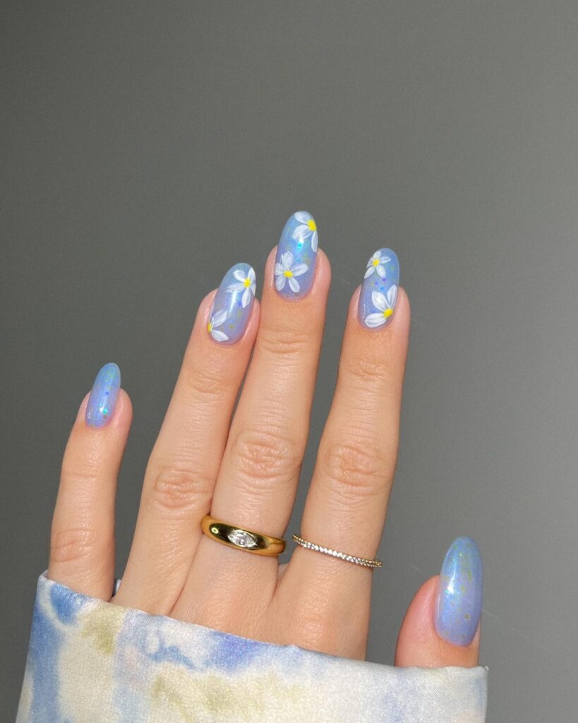 nails with periwinkle shimmer base and hand-painted white daisies with yellow centres