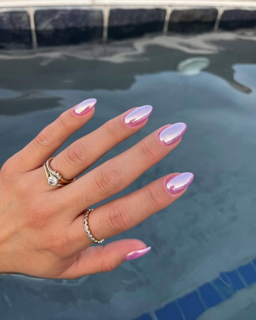 nails in bright pink chrome with iridescent pearl sheen