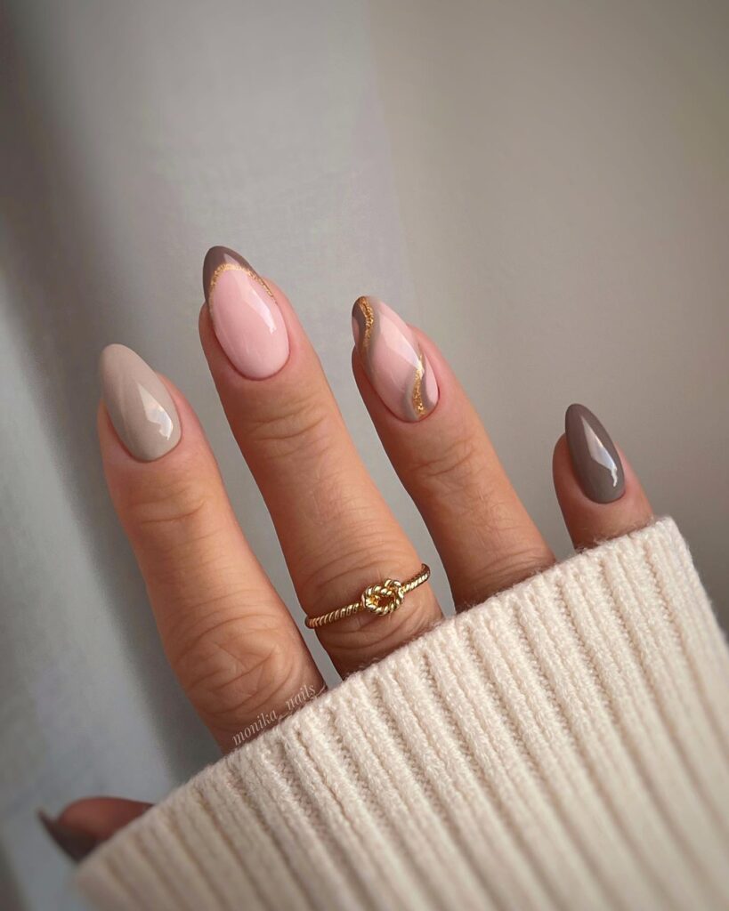 nails in beige to mocha ombre with gold foil swirl