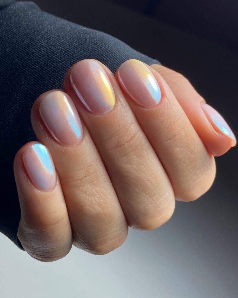 round nails in sheer nude with aurora borealis chrome shimmer